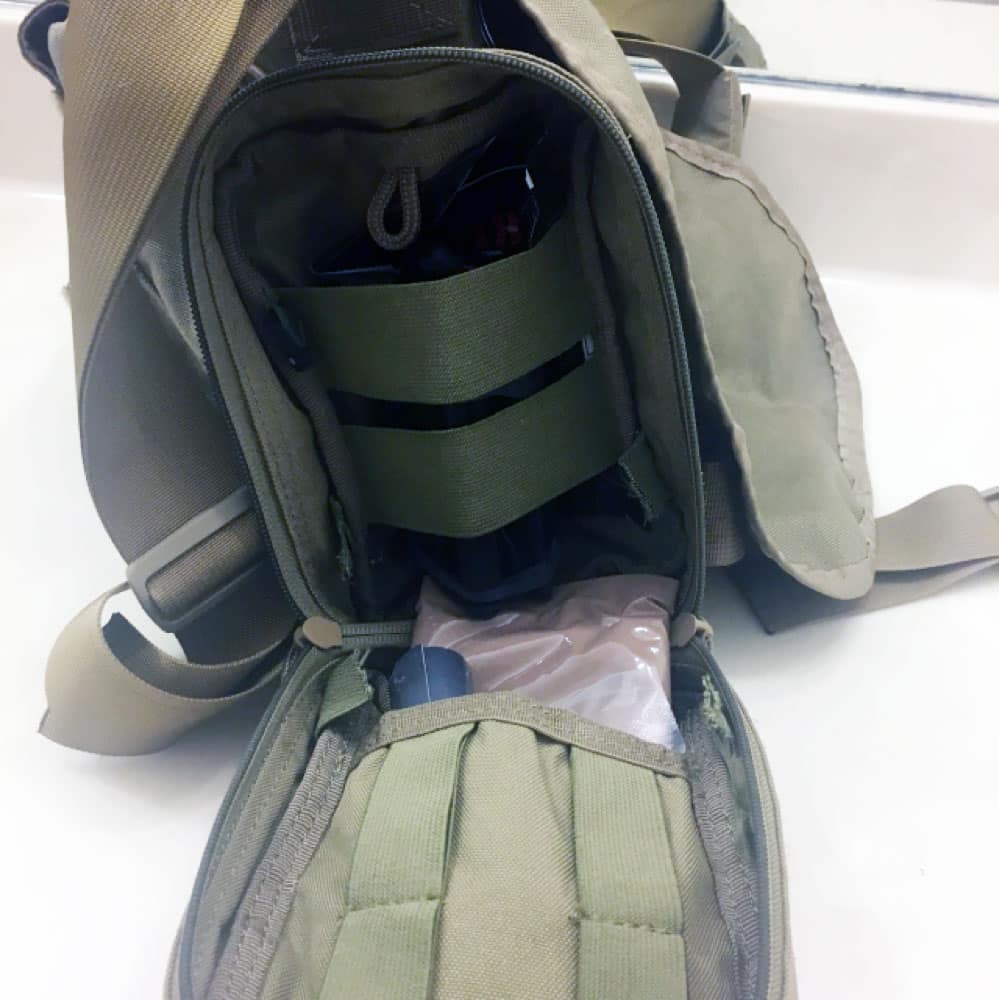 A dedicated first-aid pouch is a must. The one hear features dressings, combat gauze, shears, and other necessities.