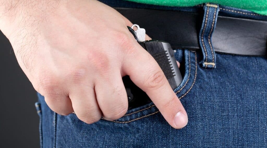 Man Pulling Gun Out Of Pocket