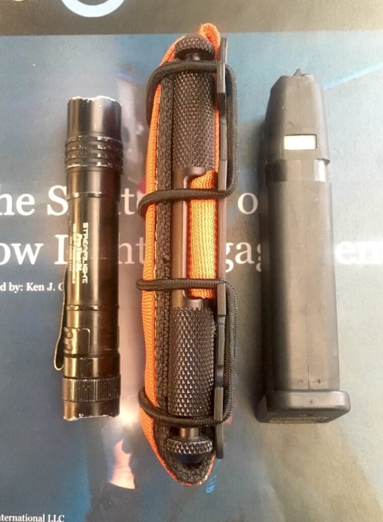 The Flatpack setup for carrying in a pocket with the belt loops removed, and shown with a Glock 17 magazines and a Streamlight PT2L for thickness comparison.