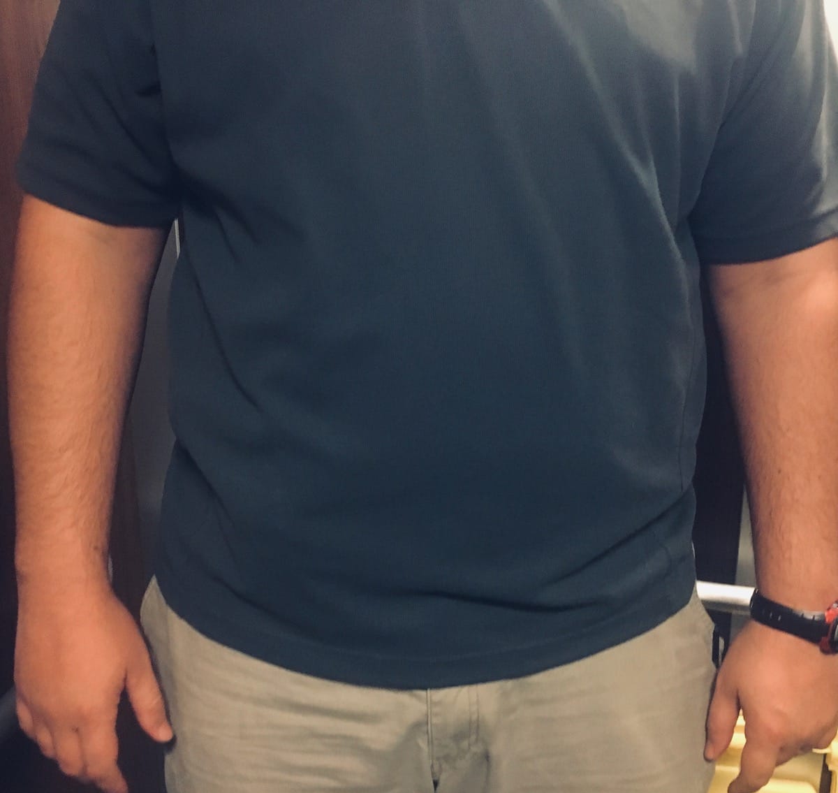 The split loop belt attachment is just visible through the closed front cover garment.