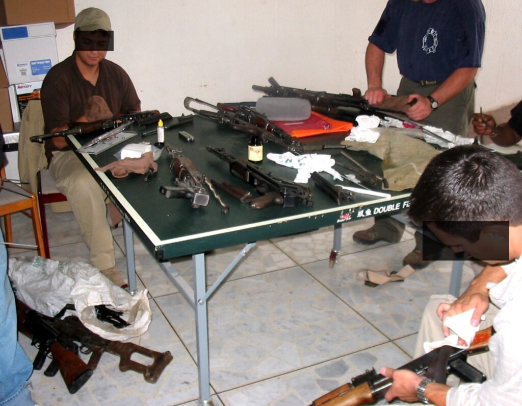 Weapon maintenance was endless in the desert. Note the PKM machine gun on the floor to the left.