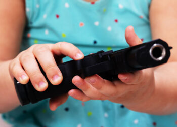 Man Arrested After Toddler Shoots Himself with Handgun Left on Bed